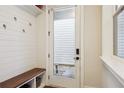 Well-lit mudroom with coat hooks, bench, storage, and view of the outdoors at 114 Village Green Ave, Woodstock, GA 30189