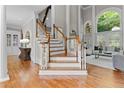 Beautiful staircase with hardwood floors, white trim, and lots of light at 3905 Merriweather Woods, Johns Creek, GA 30022