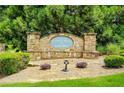 A stone sign that reads Lake Iris at King Mill is surrounded by lush landscaping at 321 Shannon Ct, Mcdonough, GA 30252