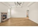 Bright living room features hardwood floors, coffered ceilings and a stone fireplace at 321 Shannon Ct, Mcdonough, GA 30252