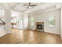 Spacious living room boasts hardwood floors, coffered ceilings and a stone fireplace at 321 Shannon Ct, Mcdonough, GA 30252