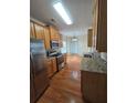 Well-lit kitchen featuring stainless steel appliances, granite countertops, and hardwood floors at 4677 Liberty Square Dr, Acworth, GA 30101