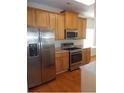 Modern kitchen featuring stainless steel appliances and wooden cabinets at 4677 Liberty Square Dr, Acworth, GA 30101