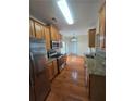 Well-lit kitchen featuring stainless steel appliances, granite countertops, and hardwood floors at 4677 Liberty Square Dr, Acworth, GA 30101