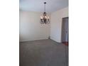Spacious living room with a decorative chandelier and neutral carpet at 4677 Liberty Square Dr, Acworth, GA 30101