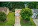 An aerial view of a well-manicured lawn and a charming single-Gathering home at 965 Under Ct, Sugar Hill, GA 30518