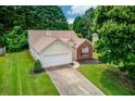 Charming single-Gathering home with a two-car garage and well-manicured front lawn at 965 Under Ct, Sugar Hill, GA 30518