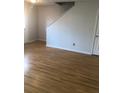 Open-concept living room with hardwood floors, showcasing ample space and a staircase at 1843 Grove Way, Hampton, GA 30228