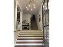 Bright foyer with a modern chandelier, staircase, and classic decor, creating a welcoming entrance at 2313 Saint Davids Nw Sq # 12, Kennesaw, GA 30152
