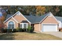 Close up of a well-maintained home with manicured shrubbery and a two car garage at 3625 Ennfield Ln, Duluth, GA 30096