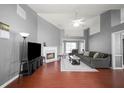 Open living room featuring hardwood floors, fireplace, ceiling fan, and plenty of natural light at 3625 Ennfield Ln, Duluth, GA 30096