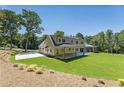 Rear view of a two-story home with a large covered patio and spacious backyard at 779 Hicks Rd, Canton, GA 30115
