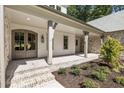 Charming front porch with stone accents and a decorative entrance door at 779 Hicks Rd, Canton, GA 30115