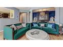 Elegant living room showcasing designer sofas, light wood floors, a patterned screen, and a marble-topped coffee table at 1600 Brisbane Drive, Dacula, GA 30019