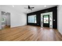 Inviting living room features dark wood accent wall, large windows, and hardwood floors at 270 Harmony Woods Dr, Dallas, GA 30157