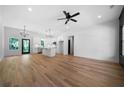 Bright, open-concept living room and kitchen area with hardwood floors and stylish light fixtures at 270 Harmony Woods Dr, Dallas, GA 30157