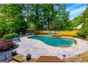 Beautiful pool area with a cabana, lounge chairs, and lush landscaping creating a private oasis at 2882 Clary Hill Ne Dr, Roswell, GA 30075