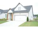 Attractive home featuring a side lawn, a two-car garage, a concrete driveway, and craftsman style columns at 423 Ward Ln, Woodstock, GA 30188