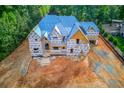 New home construction featuring pre-siding wrap and new roof on a lot with newly graded dirt at 2808 Carson Garrett Ct, Buford, GA 30519
