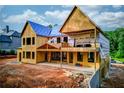 Unfinished two-story home boasting an expansive deck and natural light through large window placements at 2808 Carson Garrett Ct, Buford, GA 30519