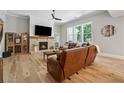 Cozy living room with a brick fireplace, hardwood floors, and ample seating at 3445 Henderson Dr, Cumming, GA 30041