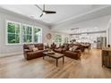 Open-concept living room featuring hardwood floors and abundant natural light at 3445 Henderson Dr, Cumming, GA 30041