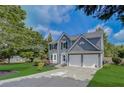 Charming two-story home with a well-manicured lawn, beautiful landscaping, and an attached two-car garage at 870 Underhill Ct, Sugar Hill, GA 30518