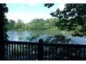 A scenic lake view from a wooden porch, surrounded by lush green trees at 2814 Shellbark Rd, Decatur, GA 30035