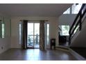 Bright living room with tile floors, sliding glass doors to a porch, and staircase at 2814 Shellbark Rd, Decatur, GA 30035