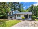 Two-story home featuring a partial white brick facade, complemented by blue siding and a covered carport at 479 Charter Oak Sw Dr, Atlanta, GA 30331