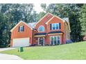 Well-maintained brick home with lush front lawn and mature trees offering curb appeal at 1890 Turtle Creek Way, Lawrenceville, GA 30043