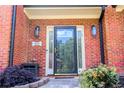 Close up of a decorative black front door with sidelights and stylish exterior lighting at 1890 Turtle Creek Way, Lawrenceville, GA 30043