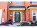 Elegant entryway with a decorative front door, brick facade, and manicured landscaping at 1890 Turtle Creek Way, Lawrenceville, GA 30043