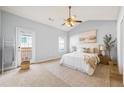 Bright main bedroom with vaulted ceiling, ceiling fan, and private balcony access at 7177 Fringe Flower Dr, Austell, GA 30168