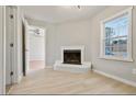 Bright living room featuring a charming white brick fireplace and ample natural light from the window at 1382 Bennett Rd, Grayson, GA 30017