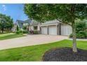 Spacious driveway leading to a three-car garage, enhanced by well-manicured lawn and tasteful landscaping at 337 Spotted Ridge Cir, Woodstock, GA 30188