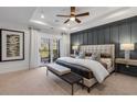 Serene main bedroom featuring a tray ceiling, private balcony, and stylish decor at 1109 Rivard Nw Cir, Atlanta, GA 30318