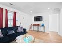 Cozy living room with a dark sofa, and wall-mounted TV at 251 Aurora Nw Ave, Atlanta, GA 30314