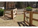 Wooden fence surrounding the backyard of the property with grass and trees at 2184 E Cherokee Dr, Woodstock, GA 30188