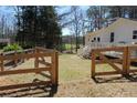 View of backyard with wooden fence, home, and deck at 2184 E Cherokee Dr, Woodstock, GA 30188