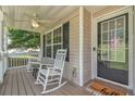 Cozy front porch featuring rocking chairs, ceiling fan, and a 'hello' welcome mat at 329 Kyles Cir, Hiram, GA 30141