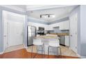 Bright kitchen with granite countertops, stainless steel appliances and a tile floor at 1850 Cotillion Dr # 4419, Atlanta, GA 30338