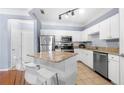 Well-lit kitchen featuring granite countertops, stainless steel appliances, and breakfast bar at 1850 Cotillion Dr # 4419, Atlanta, GA 30338