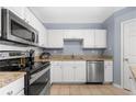 Nicely appointed kitchen featuring granite countertops, stainless appliances, and white cabinetry at 1850 Cotillion Dr # 4419, Atlanta, GA 30338