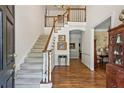 Bright foyer features a staircase with wood railing and an open floor plan to the dining room at 4070 Ridgehurst Se Dr, Smyrna, GA 30080