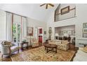 Open-concept living room with tall ceilings, elegant furnishings, and bright natural light at 4070 Ridgehurst Se Dr, Smyrna, GA 30080