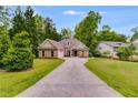 Beautiful single-Gathering home with a long driveway, a well-kept lawn, and mature trees at 5200 Woodmont Dr, Villa Rica, GA 30180