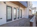 Exterior view of brick patio outside unit featuring a white brick exterior and three windows at 896 Farmstead Rd # 162, Suwanee, GA 30024