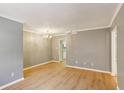 View of the living room and kitchen space featuring modern wood floors and neutral paint at 91 Rumson Ne Rd # B25, Atlanta, GA 30305