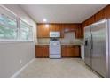 Bright kitchen features wooden cabinets, stainless steel appliances, and ample counter space at 115 Delmoor Nw Dr, Atlanta, GA 30311